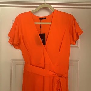 Orange fun and sexy dress with slit up the front.